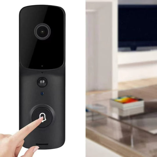 Smart doorbell with a hand pressing the button, blurred living room in the background
